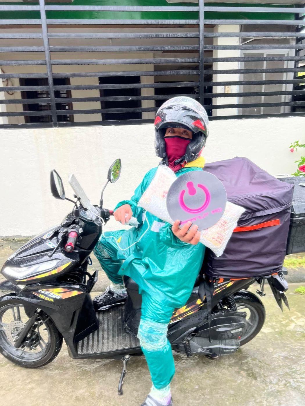 Lalamove rider on a motorcycle with a Peanut PC parcel