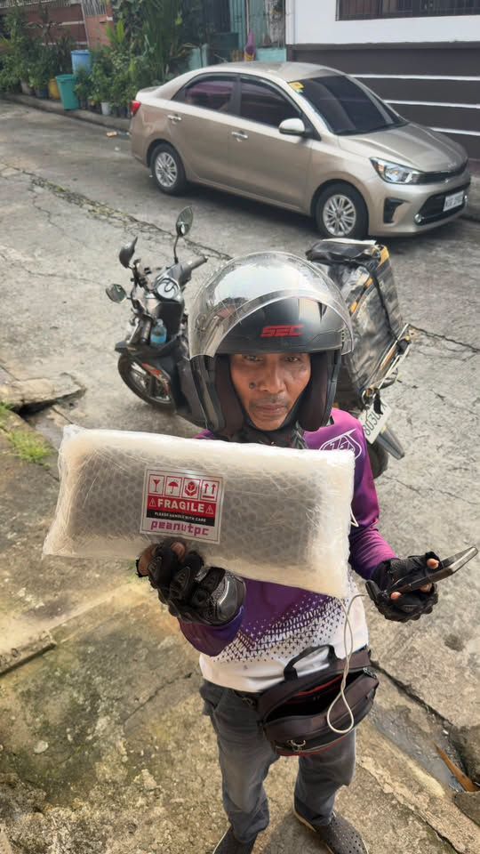 Rider holding a fragile-labeled GPU parcel