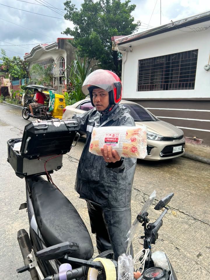 Rider beside a motorcycle with a packed graphics card