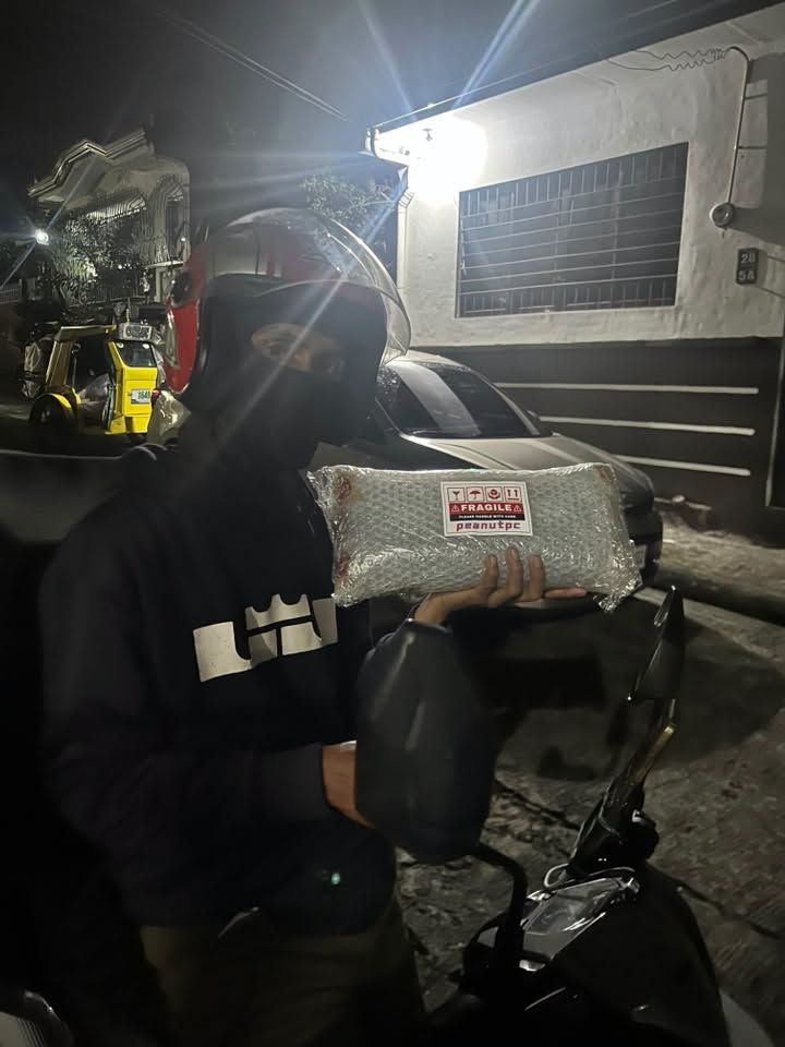 Night dispatch, rider with a wrapped GPU parcel