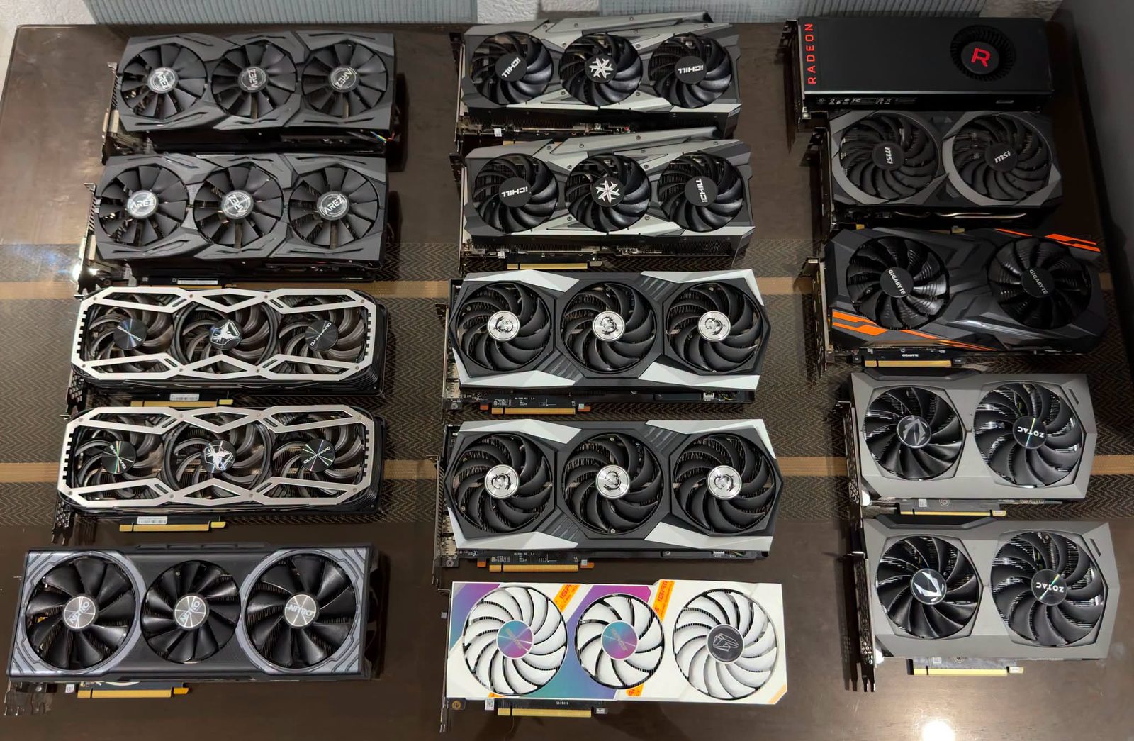 A bench of used GPUs laid out for photos before they ship